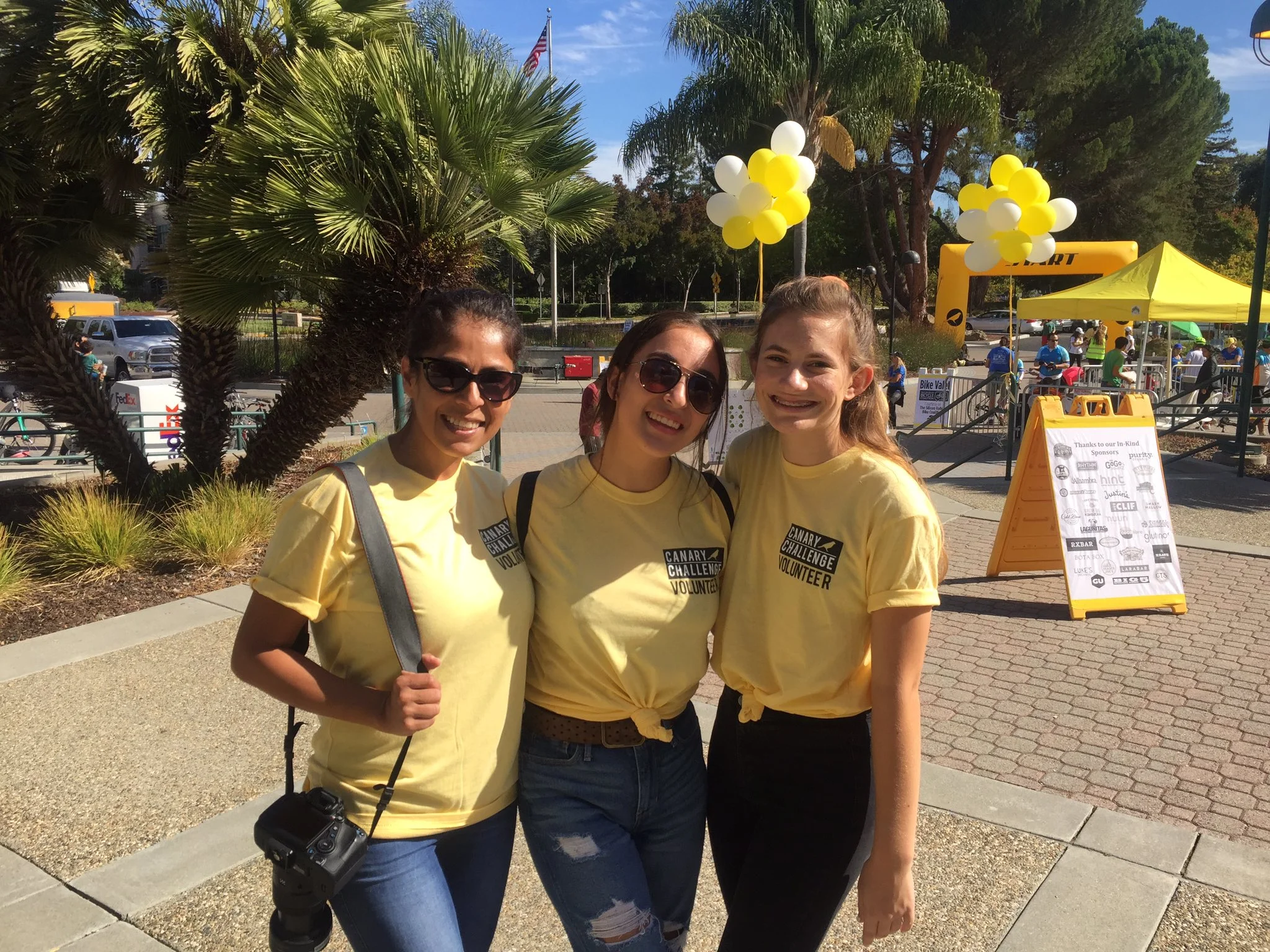 Historic photo of Canary Challenge volunteers in signature yellow shirts from past community fundraising events